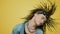 Rocker waving head on yellow background. Hipster moving body to music