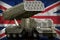 Rocket artillery, missile launcher with grey camouflage on the United Kingdom UK national flag background. 3d Illustration