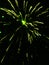 Rocket exploding in the sky at. Night into green sparks