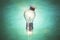 Rocket light bulb in graduate cap on green blackboard background