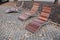 Rocking chair on the pavement under the trees in the square. wooden deck chairs made of tropical wood for one person in the park.