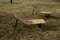 Rocking chair on the pavement under the trees in the square. wooden deck chairs made of tropical wood for one person in the park.