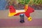 Rocking chair on a red and blue metal spring made of natural wood in the shape of an airplane on a playground