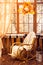 Rocking-chair in the room with wooden walls, wicker wreath in au