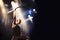 Rocking out. A guitarist on stage with his band beneath strobe lights in a nightclub.