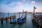 Rocking the Venetian gondolas against San Giorgio Maggiore Church on the Grand Canal