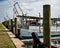 ROCKPORT, TX - 14 FEB 2023: Row of wooden pilings and boats in the marina