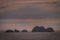 Rocks above water of Wollaston archipelago under cloudscape, Cape Horn, Chile