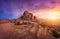 Rocks against amazing cloudy sky in desert at sunset