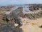 The rocks appear as a painting on the beach