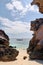 Rocks on the beach, boat on the sea beyond