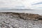 Rocks and beach with Cliffs of Moher in background in Inisheer island