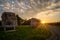 Rocks bench vineyard landscape with sunstars and cloudy sky