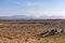 Rocks in a bog with Twelve Bens mountains in background