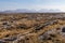 Rocks in a bog with Twelve Bens mountains in background