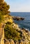 Rocks and cliffs shoreline of Cap Ferrat cape hosting Saint-Jean-Cap-Ferrat resort town on at French Riviera in France