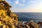 Rocks and cliffs shoreline of Cap Ferrat cape hosting Saint-Jean-Cap-Ferrat resort town on at French Riviera in France