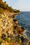 Rocks and cliffs shoreline of Cap Ferrat cape hosting Saint-Jean-Cap-Ferrat resort town on at French Riviera in France