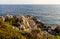 Rocks and cliffs shoreline of Cap Ferrat cape hosting Saint-Jean-Cap-Ferrat resort town on at French Riviera in France