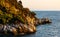 Rocks and cliffs shoreline sunset landscape of Cap Ferrat cape hosting Saint-Jean-Cap-Ferrat resort town in France