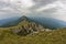 Rocks and cliffs under dark clouds trekking path at Suva Planina mountain