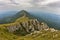 Rocks and cliffs under dark clouds trekking path at Suva Planina mountain