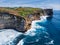 Rocks of the coast of the Bukit Peninsula in Bali. The sheer cliffs of the southern coast of Bali are washed by a clear azure