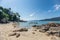 Rocks on coastline with resort on hill at Lipe