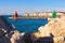 Rocks and colorful architecture details at Piran harbor, Istria