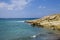 The rocks are in contact with the sea. Rocky beach, sharp rocks touching the sea, Greece island of Crete.