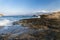 The rocks are in contact with the sea. Rocky beach, sharp rocks touching the sea, Greece island of Crete