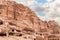 Rocks dotted with many caves carved by Nabatean craftsmen in Nabatean Kingdom of Petra in the Wadi Musa city in Jordan