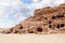 Rocks dotted with the many caves carved by Nabatean craftsmen in Nabatean Kingdom of Petra in the Wadi Musa city in Jordan