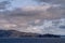 Rocks at edge of island under cloudscape, Cape Horn, Chile