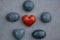 Rocks engraved with words Love, Peace, Courage, Hope, Joy surrounding a red heart