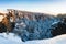 Rocks in the famous rocky city of Adrspach-Teplice rocks. Winter time trees, tourist routes and rocks covered with snow.