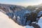 Rocks in the famous rocky city of Adrspach-Teplice rocks. Winter time trees, tourist routes and rocks covered with snow.