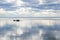 Rocks in lake with clouds mirroring in the water