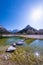 Rocks in lake Jasna with mountains Razor Prisojnik in Slovenia