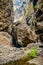 Rocks in the Masca gorge, Tenerife, showing solidified volcanic lava flow layers and arch formation. The ravine or barranco leads