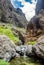 Rocks in the Masca gorge, Tenerife, showing solidified volcanic lava flow layers and arch formation. The ravine or barranco leads