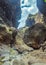 Rocks in the Masca gorge, Tenerife, showing solidified volcanic lava flow layers and arch formation. The ravine or barranco leads