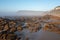 Rocks in the mist at Morgan Bay beach at sunset, Wild Coast, Eastern Cape, South Africa.