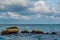 Rocks in the ocean near tropical island