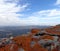 Rocks with orange lichen with landscape