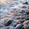 Rocks and pebbles are softly caressed by the ebbing and flowing tide