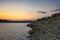 Rocks pile near the beach with orange sky at beautiful sunset