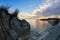 Rocks, sand, sea and a beach with a small cave at sunset, Sithonia