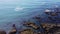 Rocks on the shore, top view. Seaside landscape, Atlantic Ocean. Sea water drone video