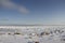 Rocks in the snow under a blue sky in the arctic, north of Arviat